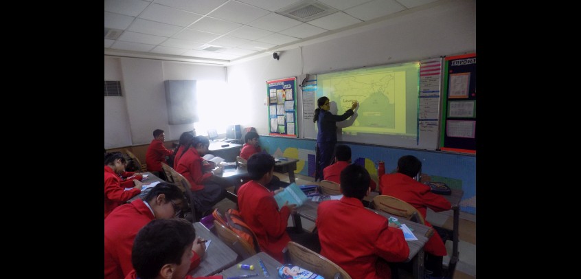 school with smart classes,teacher is teaching students with the help of smart class
