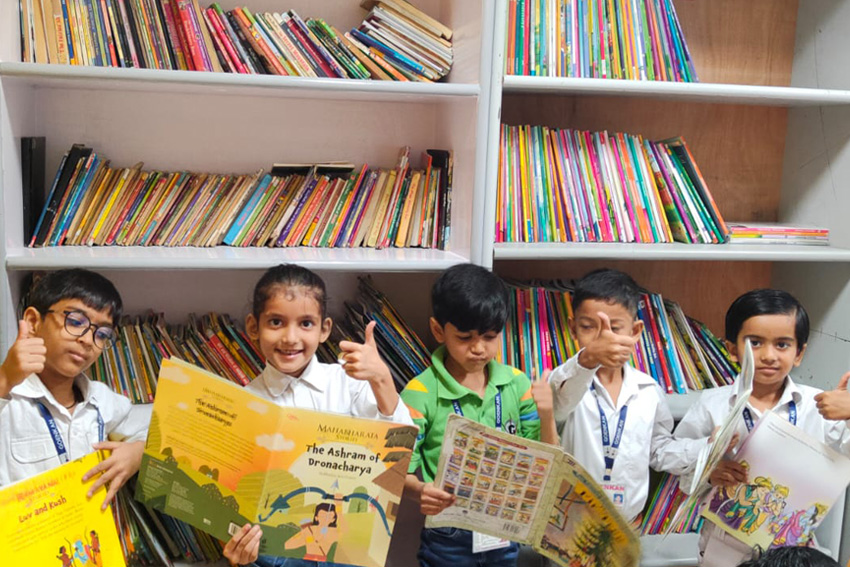 school with library, students of gd goenka studying in library
